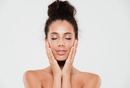 A Woman touching her face and closed eyes | What are the benefits of getting a Hydrafracial | Just Glam Aesthetics in Astoria, NY