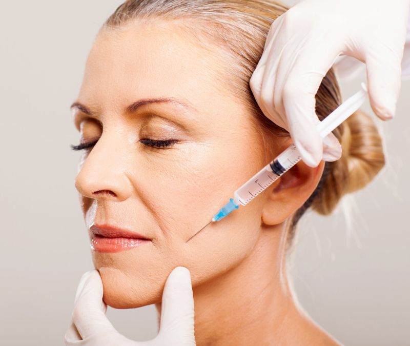 Elderly Woman Receiving Biostimulator Injection on Her Face | Just Glam Aesthetics in Astoria, NY